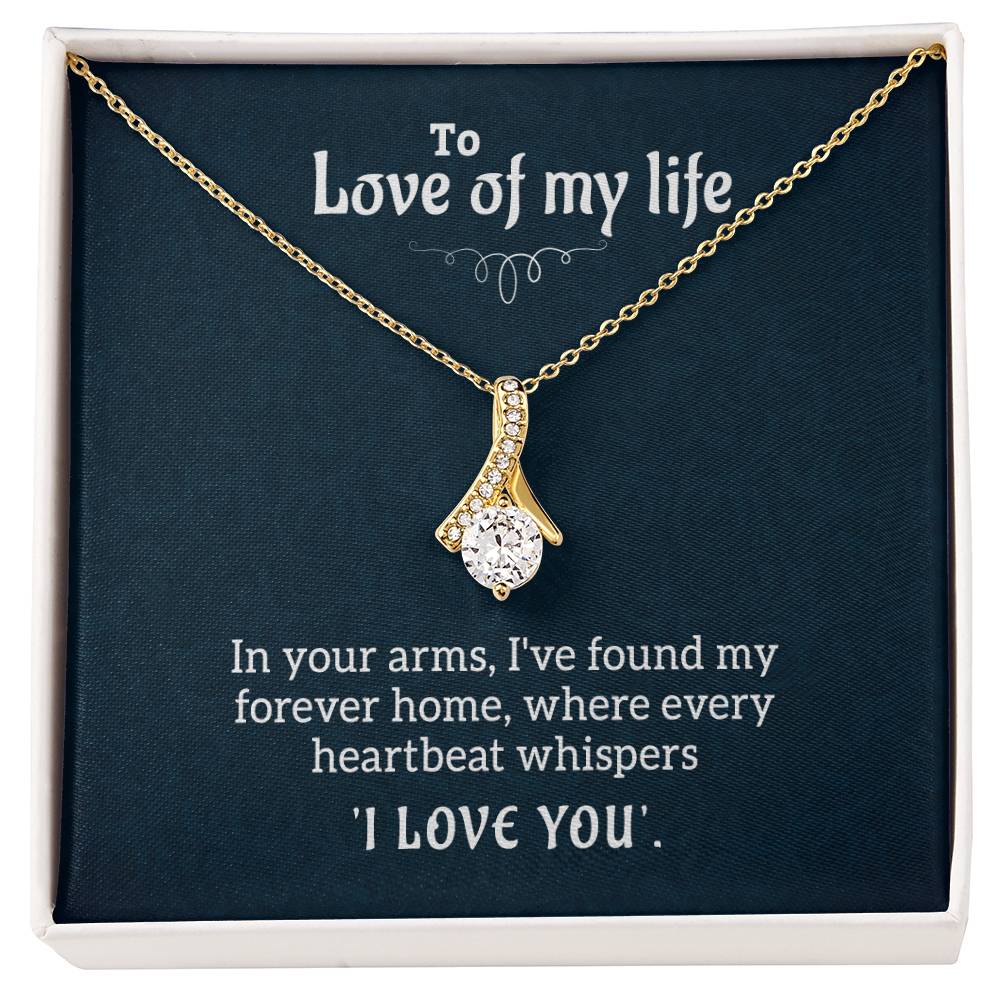 Close view of the sparkling center stone in the ribbon-shaped Alluring Beauty necklace.